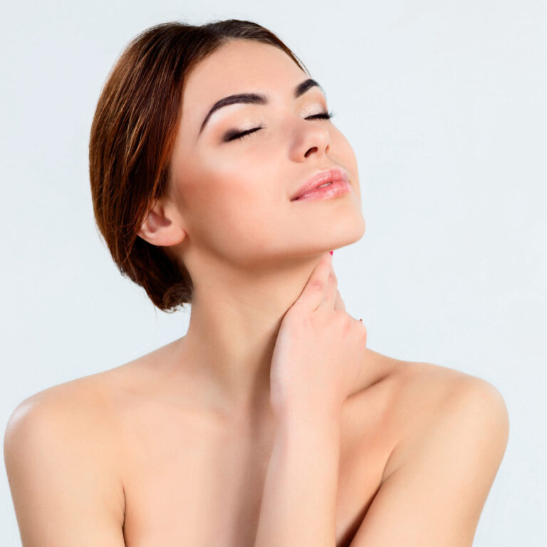 The attractive brunette beautiful girl with beautiful makeup on white background, youth and skin care concept